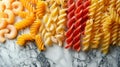 pasta collection, assorted colorful macaroni in various shapes and sizes on a marble surface, creating a vibrant Royalty Free Stock Photo