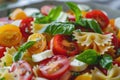 Pasta colored farfalle salad with tomatoes, mozzarella and basil