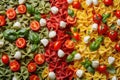 Pasta colored farfalle salad with tomatoes, mozzarella and basil