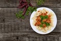 Pasta Conchiglie and meatballs with tomato sauce on rustic wooden background. Top view