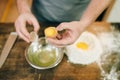 Pasta cooking process, male chef hands with egg Royalty Free Stock Photo