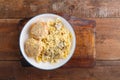 Pasta in a creamy sauce with mushrooms and chicken meatballs in a beige plate on a wooden table. copy space Royalty Free Stock Photo