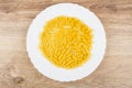Pasta different form in white plate on wooden table Royalty Free Stock Photo