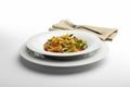 Pasta dish Macaroni and vegetables with napkin and fork