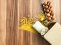 Pasta, eggs, chickpeas, rice, oatmeal and sunflower oil set on a wooden background, donation set. necessary products