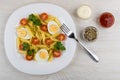 Pasta with eggs, tomatoes, parsley, fork, bowls with condiment, Royalty Free Stock Photo