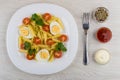 Pasta with eggs, tomatoes, parsley, fork, bowls with condiment, Royalty Free Stock Photo