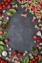 Pasta farfalle, cherry tomatoes, garlic, olive oil and basil on dark background with copy space Royalty Free Stock Photo