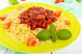 Pasta Farfalle with chicken, tomato and tomato sauce on a plate on a white wooden background.