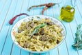 Pasta farfalle with turkey, pesto sauce and rosemary in serving plate over wooden turquoise background Royalty Free Stock Photo