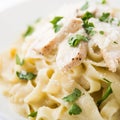 Pasta fettuccine alfredo with chicken, parmesan and parsley on white background close up Royalty Free Stock Photo