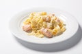 Pasta fettuccine alfredo with chicken, parmesan and parsley on white plate. Italian cuisine.