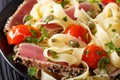 Pasta fettuccine with tuna steak, tomatoes and capers macro. horizontal Royalty Free Stock Photo