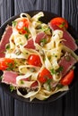 Pasta fettuccine with tuna steak, tomatoes and capers macro. Top Royalty Free Stock Photo