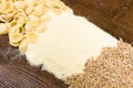 Wheat grains, pasta and flour on a wooden table