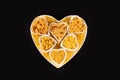 Pasta food selection in heart shaped porcelain dishes over black background. Royalty Free Stock Photo