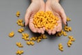 pasta in the form of spirals lie in female palms Royalty Free Stock Photo