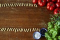 Pasta forming a frame with tomatoes and herbs