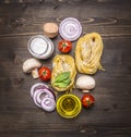 Pasta with fresh vegetables , preparation with flour on rustic wooden background, top view. Vegetarian food healthily cooking