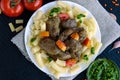 Pasta and fried goose liver (chicken, duck) with pesto and tomato on a black background Royalty Free Stock Photo