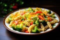 Pasta fusilli with broccoli, carrot, corn, and tomatoes