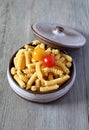 Pasta fusilli and two cherry tomatoes Royalty Free Stock Photo