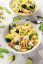 Pasta with green vegetables broccoli, Mange tout and creamy sauce in white plate Royalty Free Stock Photo