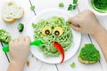 Pasta with green vegetables pesto shaped cute monster - healthy