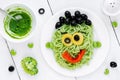 Pasta with green vegetables pesto shaped Frankenstein monster - Royalty Free Stock Photo