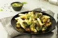 Pasta with green vegetables roasted brussel sprouts and pesto sauce Royalty Free Stock Photo