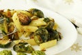 Pasta with green vegetables roasted brussel sprouts and pesto sauce