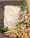 Pasta, herbs and paper on wooden background Royalty Free Stock Photo