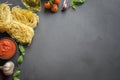 Pasta ingredients for cooking Italian dishes, tagliatelle, tomatoes, basil, oil and garlic