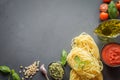 Pasta ingredients for cooking Italian dishes, tagliatelle, tomatoes, basil, oil and garlic.