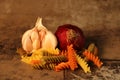 Pasta with ingredients on stone background