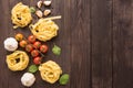 Pasta ingredients. tomato, garlic, pepper, and mushroom on woode