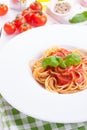 Pasta ingredients - tomatoes, olive oil, garlic, italian herbs, fresh basil, salt and spaghetti on a black stone background Royalty Free Stock Photo