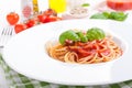 Pasta ingredients - tomatoes, olive oil, garlic, italian herbs, fresh basil, salt and spaghetti on a black stone background Royalty Free Stock Photo