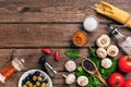 Pasta ingredients - tomatoes, olive oil, garlic, italian herbs, fresh basil, salt and spaghetti on a wooden background Royalty Free Stock Photo