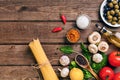 Pasta ingredients - tomatoes, olive oil, garlic, italian herbs, fresh basil, salt and spaghetti on a wooden background Royalty Free Stock Photo