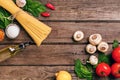 Pasta ingredients - tomatoes, olive oil, garlic, italian herbs, fresh basil, salt and spaghetti on a wooden background Royalty Free Stock Photo