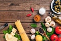 Pasta ingredients - tomatoes, olive oil, garlic, italian herbs, fresh basil, salt and spaghetti on a wooden background Royalty Free Stock Photo