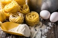 Pasta and ingredients on wooden background Royalty Free Stock Photo