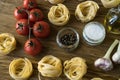 Pasta ingridients and spice on wooden surface. Royalty Free Stock Photo