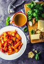 Pasta. Italian and Mediterrannean cuisine. Pasta Rigatoni with tomato sauce basil leaves garlic and parmesan cheese.