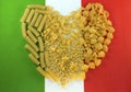 Pasta laid out in the shape of a heart on the background colors of the Italian flag