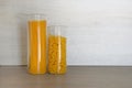 Pasta in large glass jars containers stand on gray table in kitchen. Uncooked raw italian pasta with spaghetti Royalty Free Stock Photo