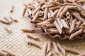 Pasta made from oat flour, scattered on a plate, on a table Royalty Free Stock Photo