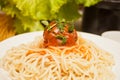 Pasta with meat balls in a tomato sauce on the white plate with fresh vegetables on the background Royalty Free Stock Photo