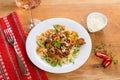 Pasta with meat, mushrums, olives and basil on a classic wood ta